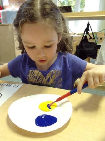 mixing_yellow_and_purple_paint_cadence_academy_preschool_yelm_2_olympia_wa-336x450