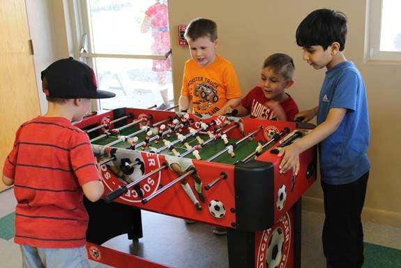 playing_foosball_at_cadence_academy_preschool_smoky_hill_aurora_co