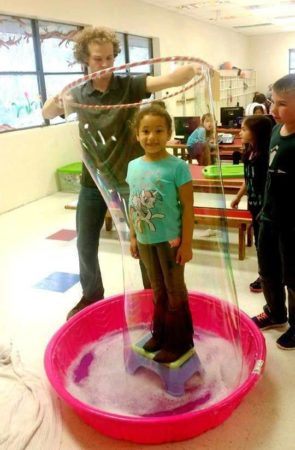 playing_with_big_bubbles_at_cadence_academy_preschool_branch_hollow_carrollton_tx-295x450