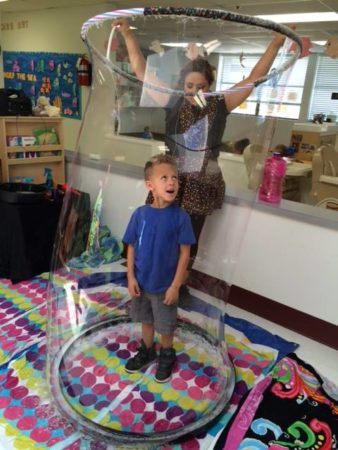 playing_with_big_bubbles_at_cadence_academy_preschool_the_colony_tx-338x450