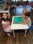 playing_with_dinosaur_cut-outs_childrens_garden_montessori_richland_wa-336x450