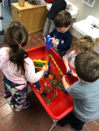 playing_with_water_toys_jonis_child_care_preschool_burlington_ct-338x450