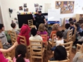 policeman_reading_to_preschool_class_cadence_academy_preschool_austin_cedar_park_tx-603x450
