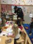 policeman_showing_children_how_handcuffs_work_cadence_academy_preschool_milwaukie_portland_or-338x450