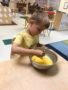 pre-kindergarten_boy_beating_eggs_with_fork_cadence_academy_preschool_chesterfield_hilltown_mo-338x450