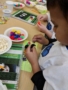 pre-kindergarten_boy_making_necklace_rogys_learning_place_hilltop_peoria_il-338x450