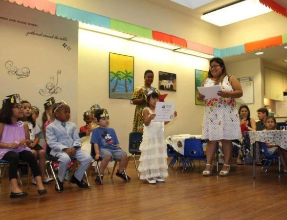 pre-kindergarten_girl_getting_a_diploma_at_cadence_academy_preschool_dallas_tx-587x450