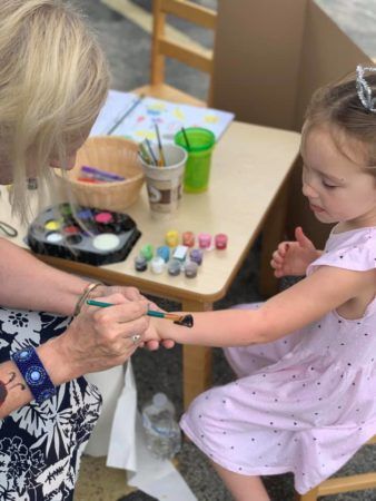 pre-kindergarten_girl_getting_paint_tattoo_cadence_academy_preschool_chesterfield_hilltown_mo-338x450