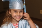 pre-kindergarten_girl_in_cap_and_gown_rogys_learning_place_lake_street_peoria_heights_il-675x450