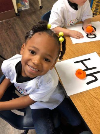 pre-kindergarten_girl_learning_letters_the_bridge_learning_center_carrollton_ga-338x450