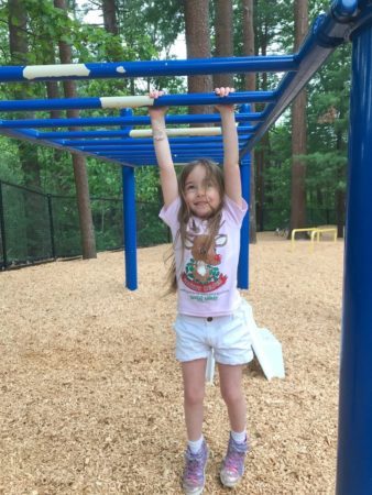 pre-kindergarten_girl_on_monkey_bars_at_cadence_academy_preschool_smithfield_ri-338x450