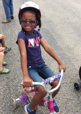 pre-kindergarten_girl_riding_tricycle_at_learning_edge_childcare_and_preschool_oak_creek_wi-321x450