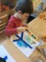 preschool-boy_painting_peace_symbol_cadence_academy_preschool_raynham_ma-338x450