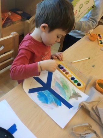 preschool-boy_painting_peace_symbol_cadence_academy_preschool_raynham_ma-338x450