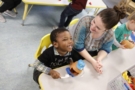 preschool_boy_and_teacher_laughing_together_winwood_childrens_center_leesburg_va-675x450