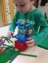 preschool_boy_building_structure_with_interlocking_pieces_cadence_academy_preschool_clackamas_or-338x450