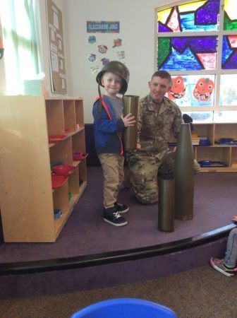 preschool_boy_checking_out_artillery_shells_canterbury_academy_at_prairie_ridge_olathe_ks-336x450