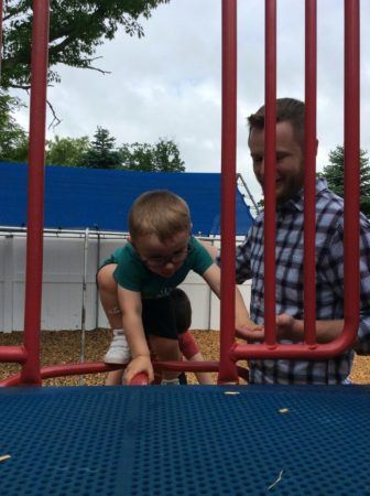 preschool_boy_climbing_onto_playground_structure_next_generation_childrens_centers_westford_ma-336x450