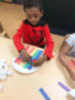 preschool_boy_creating_a_rainbow_mirror_lake_academy_villa_rica_ga-338x450