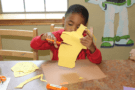 preschool_boy_cutting_construction_paper_cadence_academy_preschool_san_antonio_tx-675x450