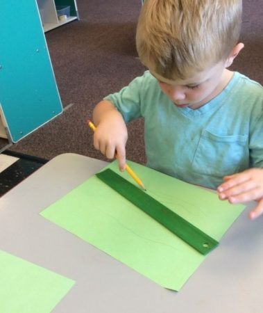 preschool_boy_drawing_lines_with_ruler_cadence_academy_preschool_seekonk_ma-379x450