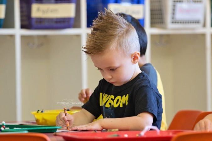 preschool_boy_drawing_with_crayons_cadence_academy_preschool_rosemeade_carrollton_tx-675x450