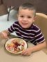 preschool_boy_eating_pie_at_thanksgiving_dinner_cadence_academy_preschool_steele_creek_charlotte_nc-338x450