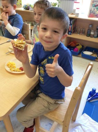 preschool_boy_enjoying_breakfast_burrito_winwood_childrens_center_ashburn_va-336x450
