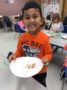 preschool_boy_enjoying_marshmallow_kebob_cadence_academy_preschool_johnston_ia-336x450