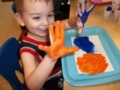 preschool_boy_enjoying_painting_with_hands_cadence_academy_preschool_sherwood_or-600x450