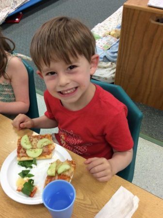 preschool_boy_enjoying_pizza_at_next_generation_childrens_centers_franklin_ma-336x450