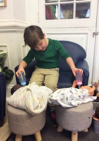 preschool_boy_feeding_two_babies_at_bala_cynwyd_school_for_young_children_bala_cynwyd_pa-316x450