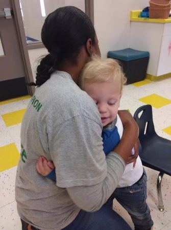 preschool_boy_getting_a_hug_from_daycare_worker_phoenix_childrens_academy_private_preschool_union_hills-335x450