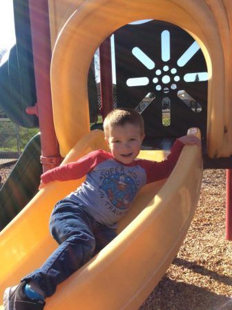 preschool_boy_going_down_slide_at_the_phoenix_schools_private_preschool_antelope_ca-336x450