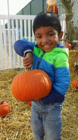 preschool_boy_holding_a_pumpkin_prime_time_early_learning_centers_farmingdale_ny-253x450