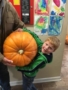 preschool_boy_holding_large_pumpkin_miss_muffets_learning_center-338x450