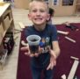 preschool_boy_holding_planted_seed_cadence_academy_preschool_ashworth_west_des_moines_ia-453x450