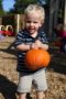 preschool_boy_holding_pumpkin_on_playground_cadence_academy_preschool_kenton_huntersville_nc-300x450