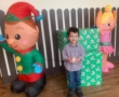 preschool_boy_in_front_of_christmas_presents_at_cadence_academy_preschool_franklin_tn-552x450