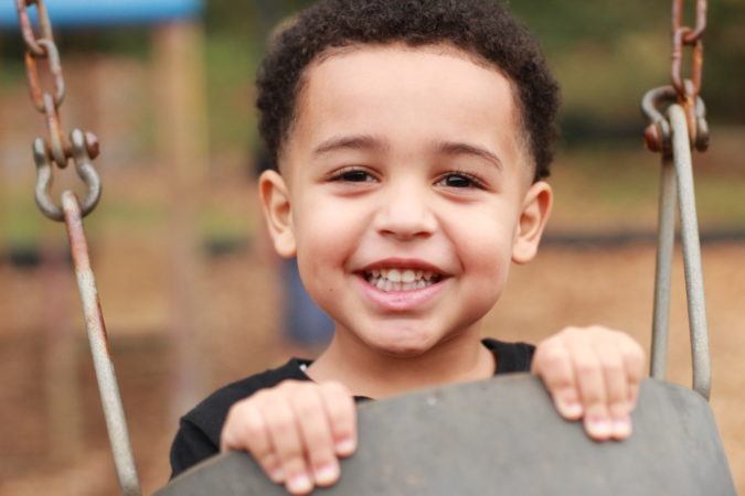 preschool_boy_in_swing_at_carolina_kids_child_development_center_fort_mill_sc-675x450