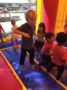 preschool_boy_jumping_in_bounce_house_cadence_academy_preschool_prairie_city_folsom_ca-333x450