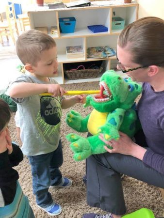 preschool_boy_learning_how_to_brush_teeth_cadence_academy_preschool_yelm_highway_olympia_wa-338x450