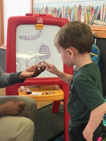 preschool_boy_looking_at_worms_sunbrook_academy_at_barnes_mill_austell_ga-338x450