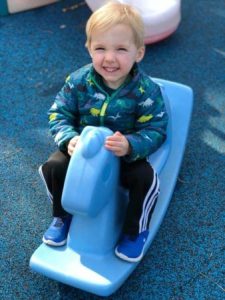 preschool_boy_on_rocking_horse_at_flanagans_preschool_plymouth_meeting_pa-338x450