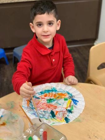 preschool_boy_painting_on_a_coffee_filter_sunbrook_academy_at_legacy_park_kennesaw_ga-338x450