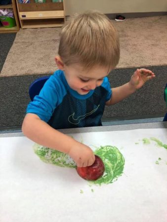 preschool_boy_painting_with_apple_jonis_child_care_preschool_canton_ct-338x450