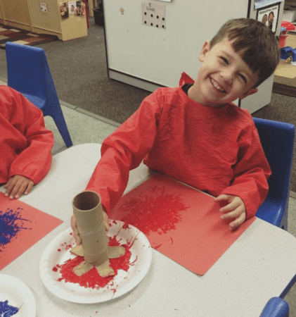 preschool_boy_painting_with_cardoard_brush_rogys_learning_place_hilltop_peoria_il-421x450