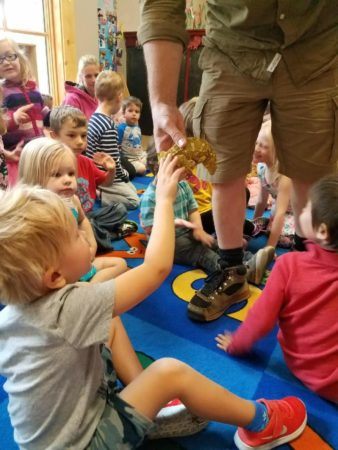 preschool_boy_petting_reptile_cadence_academy_preschool_milwaukie_portland_or-338x450