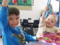 preschool_boy_picking_up_dinosaurs_with_tweezers_cadence_academy_preschool_roseville_galleria_ca-600x450