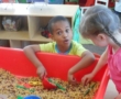 preschool_boy_playing_in_pasta_tub_prime_time_early_learning_centers_edgewater_nj-550x450